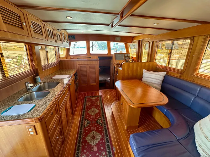 Slide: The Image of Luxurious 2006 Selene Archer 36 yacht interior with wooden finishes and cozy seating area. - 11