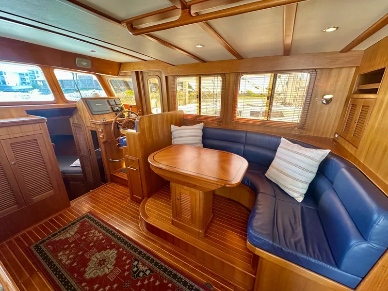Slide: The Image of Luxurious 2006 Selene Archer 36 yacht interior with wood finish and blue seating. - 12