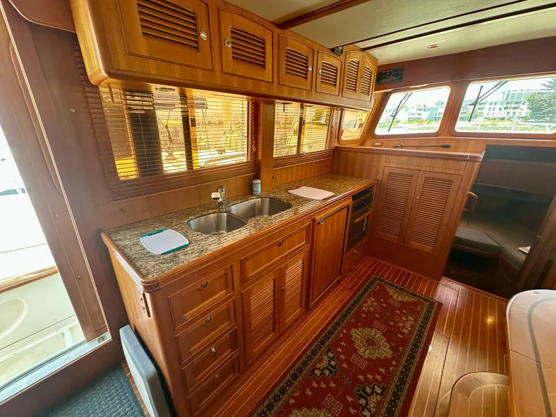 Slide: The Image of Luxurious wooden interior of 2006 Selene Archer 36 yacht with kitchenette and elegant decor. - 13