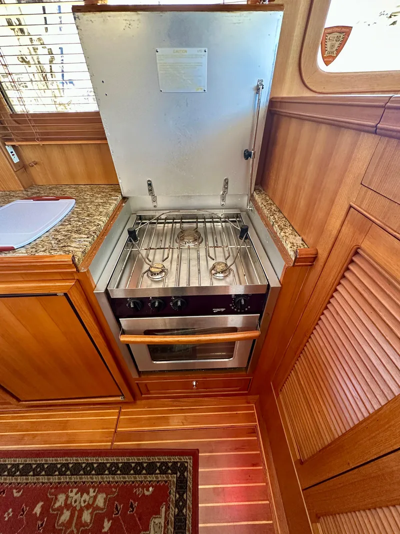 Slide: The Image of 2006 Selene Archer 36 yacht kitchen with stove and wooden cabinetry. - 14