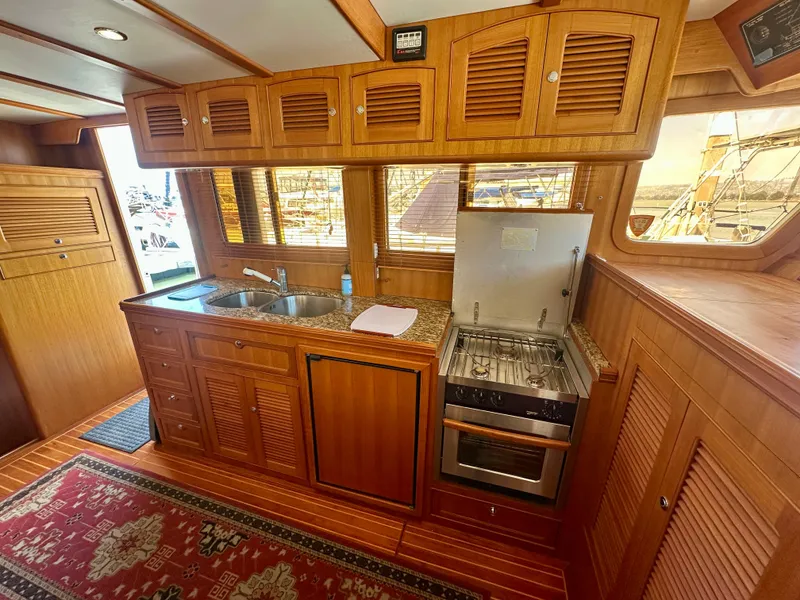 Slide: The Image of Selene Archer 36 yacht kitchen interior with wooden cabinetry and modern appliances, 2006 model. - 15
