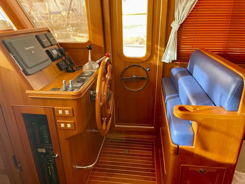 Slide: The Image of Wooden helm station of 2006 Selene Archer 36 yacht with blue seating and navigation controls. - 21