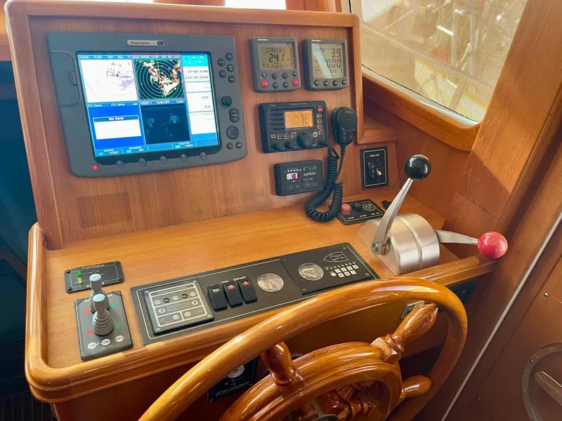 Slide: The Image of Boat helm of 2006 Selene Archer 36 with navigation equipment and wooden steering wheel. - 22