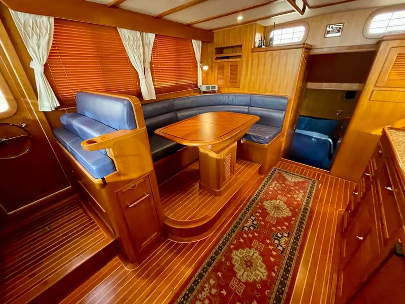 Slide: The Image of Luxurious 2006 Selene Archer 36 yacht interior with wooden finishes and blue seating. - 24