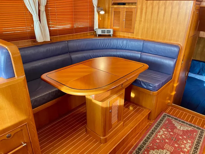 Slide: The Image of Luxurious interior of 2006 Selene Archer 36 yacht with wooden dining area and blue seating. - 26