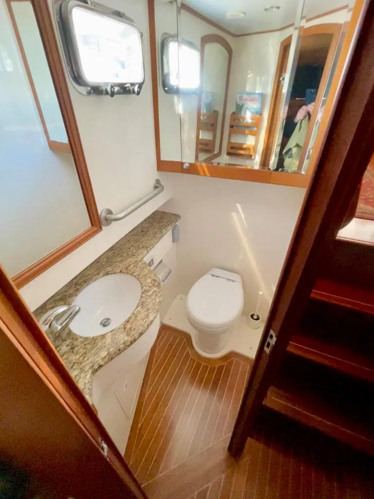 Slide: The Image of 2006 Selene Archer 36 yacht bathroom with granite countertop and wooden flooring. - 38