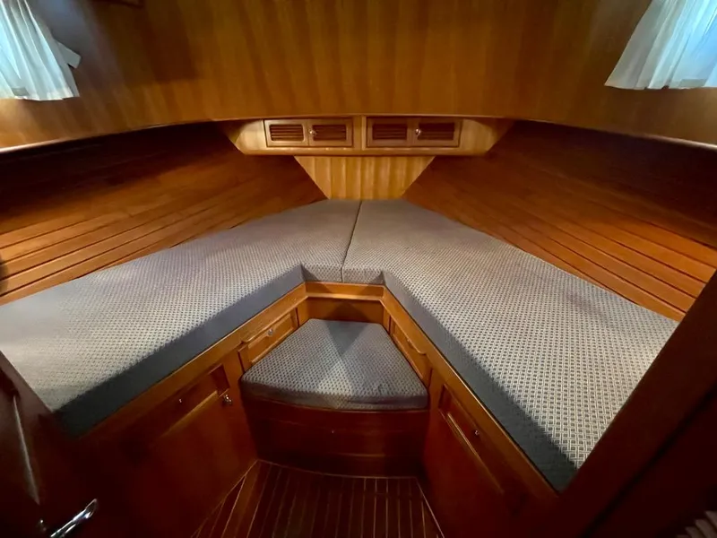 Slide: The Image of Cozy cabin interior of 2006 Selene Archer 36 yacht with wooden finish and cushioned seating. - 41