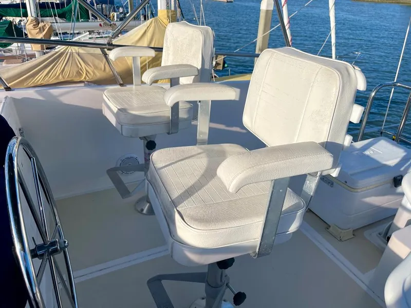 Slide: The Image of Two white captain's chairs on a 2006 Selene Archer 36 yacht deck. - 44
