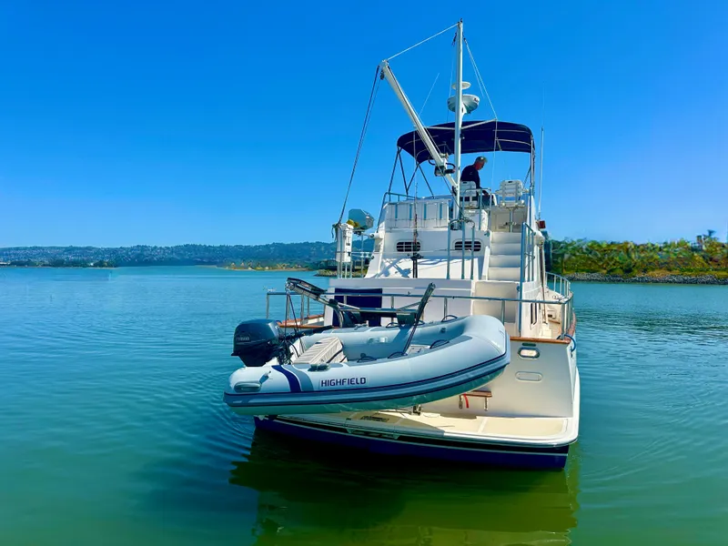 Slide: The Image of 2006 Selene Archer 36 yacht with dinghy on calm water, clear blue sky. - 6