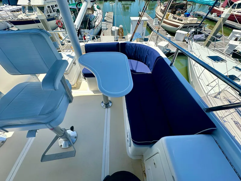 Slide: The Image of Flybridge seating area on 2006 Selene Archer 36 yacht, featuring cushioned seats and a small table. - 9