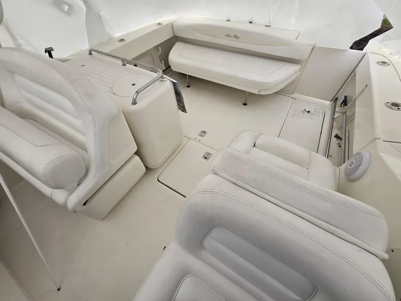 Slide: The Image of 2005 Sea Ray 290 Amberjack boat interior with white seating and spacious layout. - 10