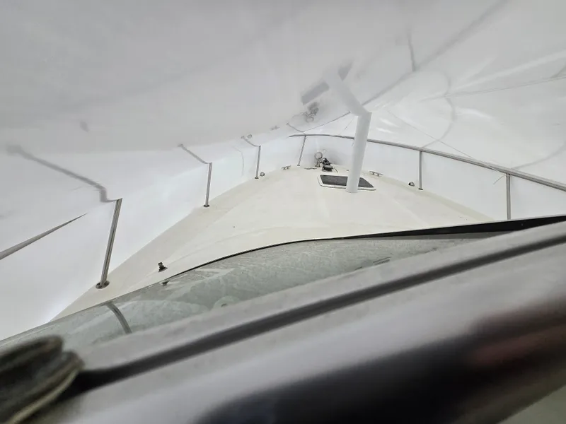 Slide: The Image of 2005 Sea Ray 290 Amberjack boat under protective cover, view from the bow. - 13