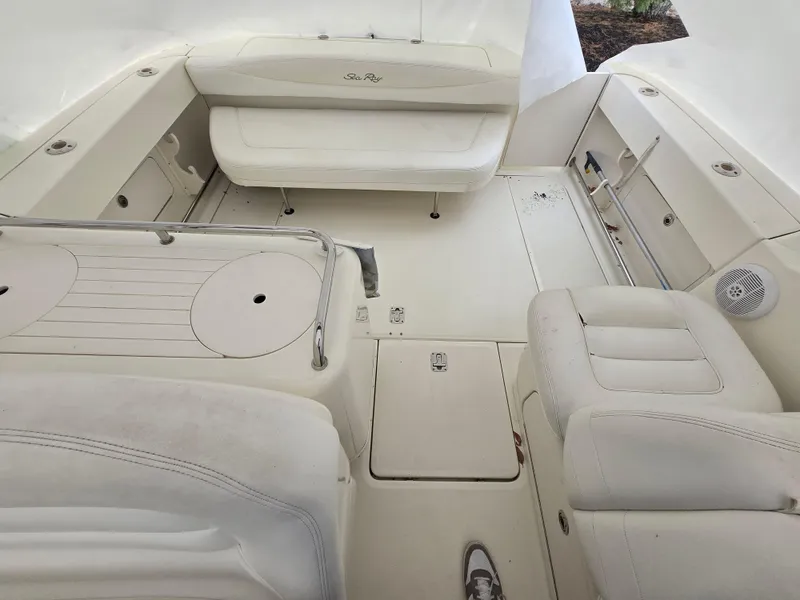 Slide: The Image of 2005 Sea Ray 290 Amberjack boat interior with white seating and deck layout. - 16