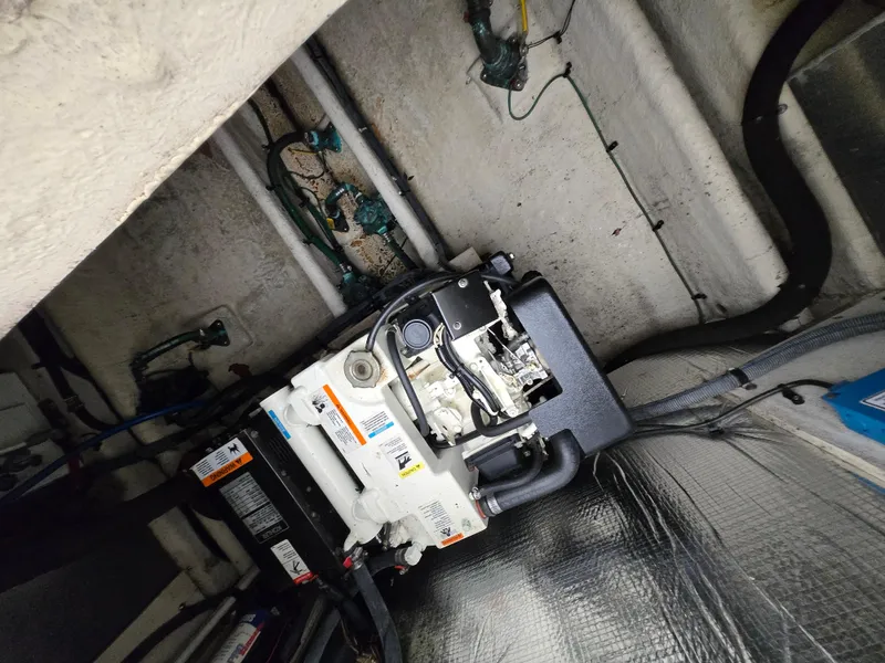 Slide: The Image of Engine compartment of a 2005 Sea Ray 290 Amberjack boat, showcasing mechanical components. - 22