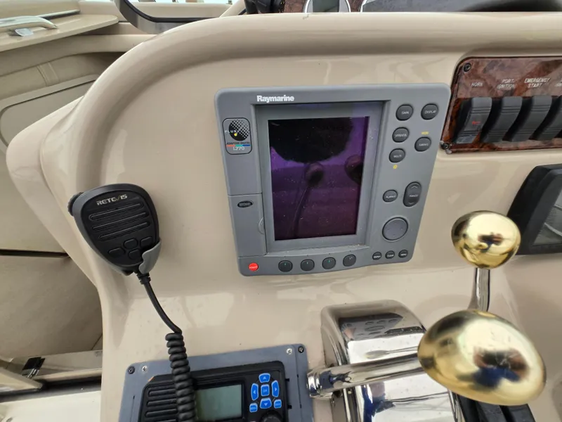 Slide: The Image of Control panel of a 2005 Sea Ray 290 Amberjack with navigation equipment and controls. - 23
