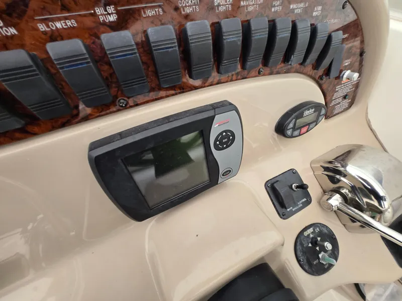 Slide: The Image of Control panel of 2005 Sea Ray 290 Amberjack boat with switches and navigation display. - 24