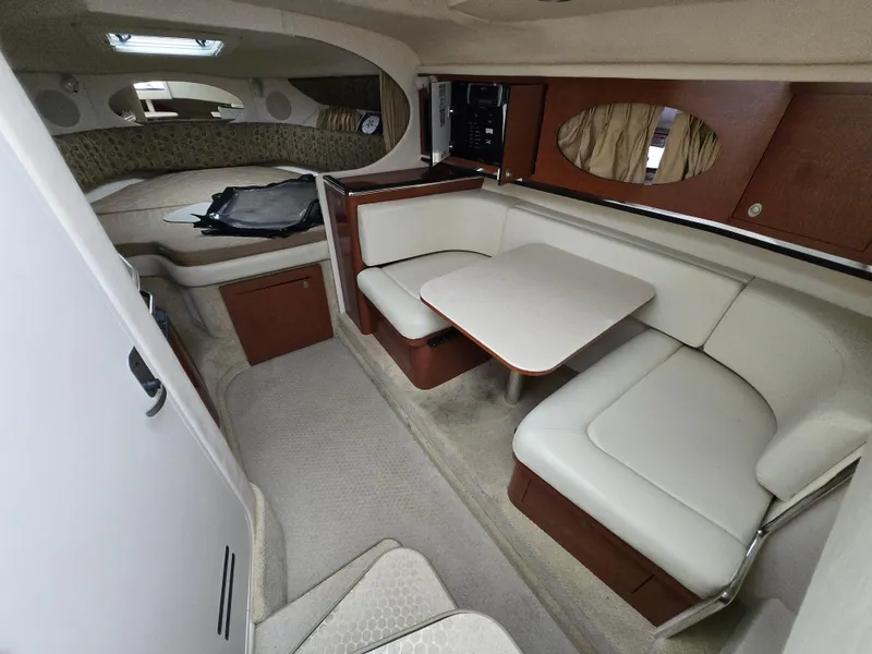 Slide: The Image of 2005 Sea Ray 290 Amberjack cabin interior with seating and table. - 3