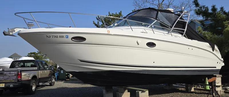 Slide: The Image of 2005 Sea Ray 290 Amberjack boat on display, parked on blocks outdoors. - 38