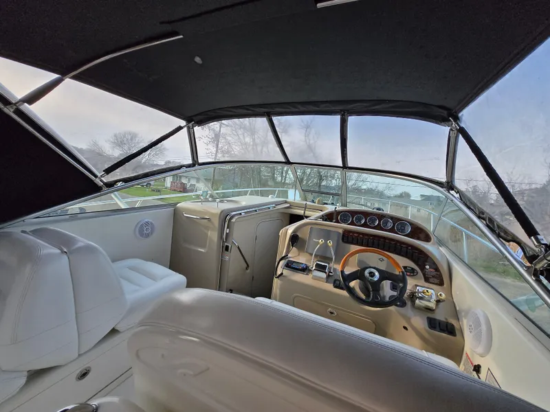 Slide: The Image of Interior view of 2005 Sea Ray 290 Amberjack boat cockpit with steering wheel and seating. - 43