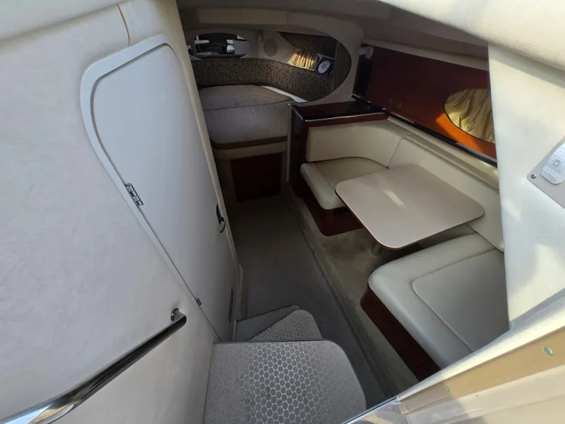 Slide: The Image of 2005 Sea Ray 290 Amberjack cabin interior with seating and table. - 44