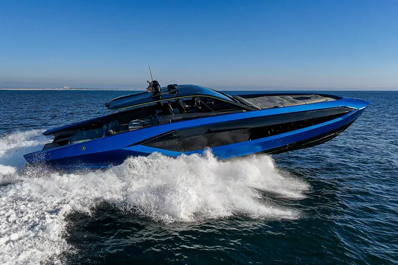Slide: The Image of 2023 Tecnomar Lamborghini 63 yacht cruising on open sea, showcasing sleek design and speed. - 13