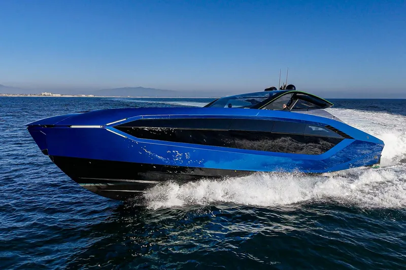 Slide: The Image of 2023 Tecnomar Lamborghini 63 yacht cruising on open water, sleek blue design. - 15