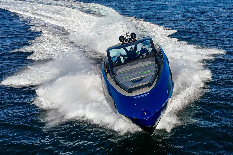 Slide: The Image of 2023 Tecnomar Lamborghini 63 yacht speeding on open water, showcasing sleek design and luxury. - 20