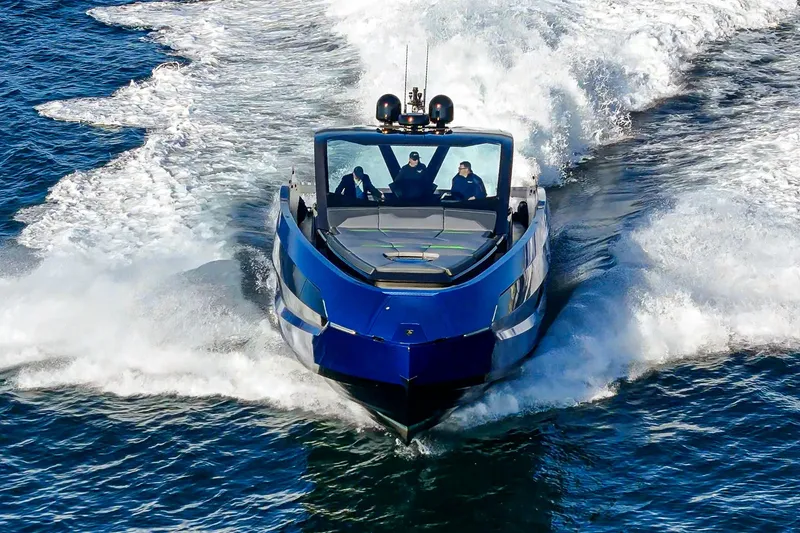Slide: The Image of 2023 Tecnomar Lamborghini 63 yacht cruising on open water, showcasing sleek design and speed. - 21