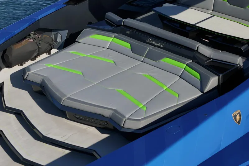 Slide: The Image of 2023 Tecnomar Lamborghini 63 yacht with sleek gray and green seating, blue exterior. - 31