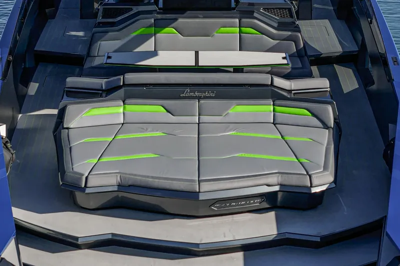 Slide: The Image of 2023 Tecnomar Lamborghini 63 yacht interior with sleek gray and green seating. - 33