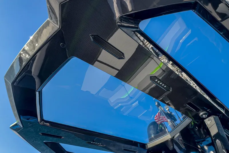 Slide: The Image of 2023 Tecnomar Lamborghini 63 yacht roof with sleek design and blue sky reflection. - 35