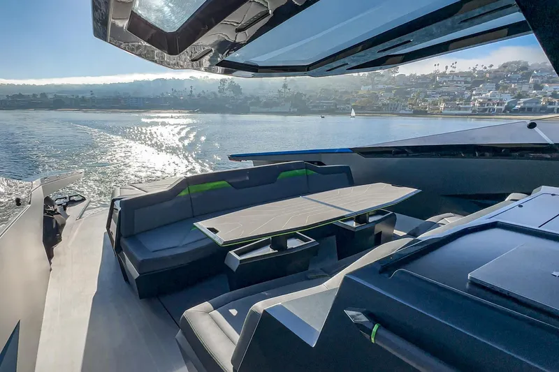 Slide: The Image of Luxurious 2023 Tecnomar Lamborghini 63 yacht interior with sleek seating and scenic water view. - 36