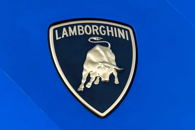 Slide: The Image of Lamborghini emblem on Tecnomar 63 yacht, 2023 model, against a blue background. - 43