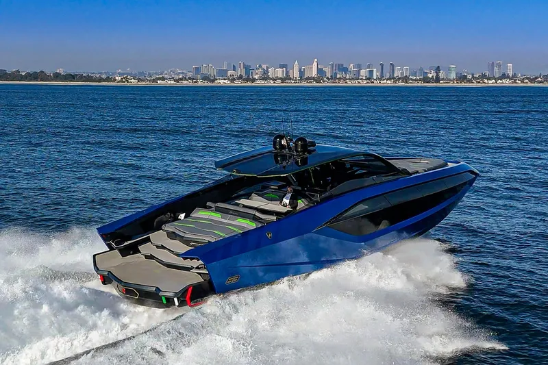Slide: The Image of 2023 Tecnomar Lamborghini 63 yacht cruising on ocean with city skyline in background. - 5
