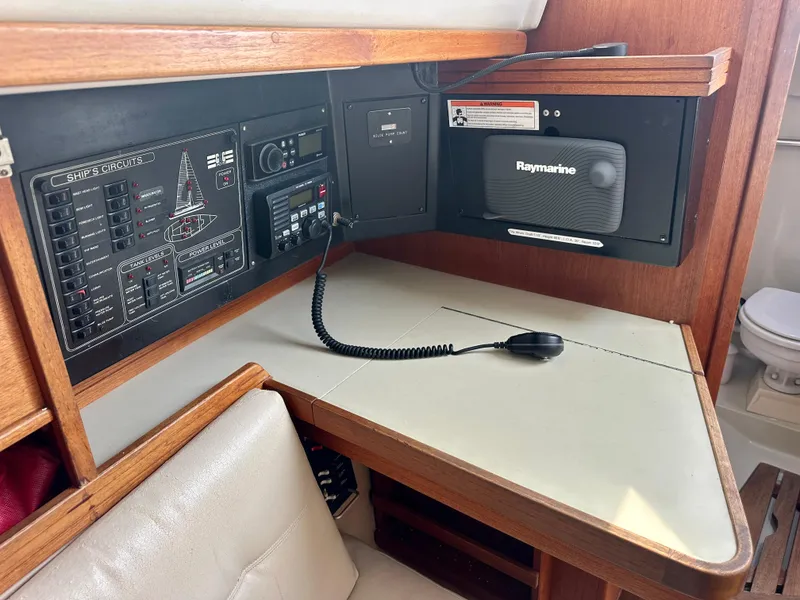 Slide: The Image of Navigation station in a 1988 C&C MKII sailboat with Raymarine equipment and control panel. - 11
