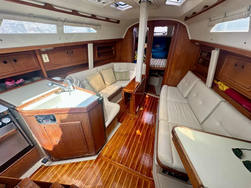 Slide: The Image of Interior of 1988 C&C MKII sailboat with wooden finish and cozy seating area. - 6