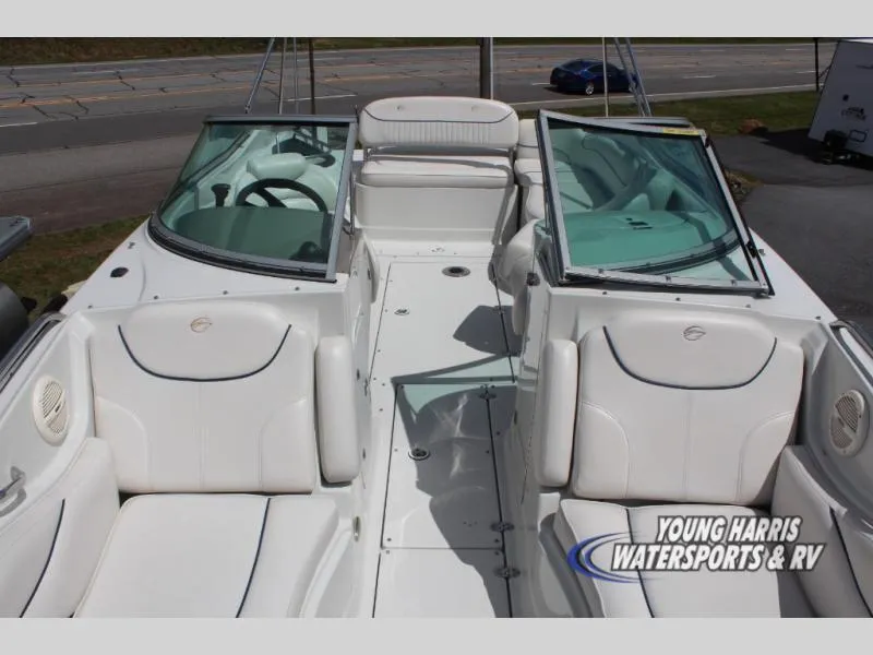 Slide: The Image of 2005 Crownline 240EX boat interior with white seating and open windshield. - 12