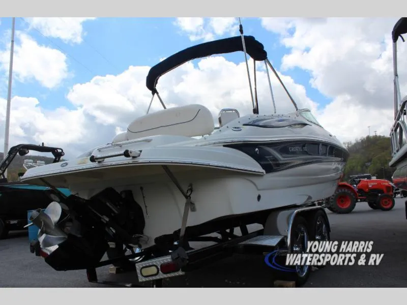 Slide: The Image of 2005 Crownline 240EX boat on trailer, displayed outdoors under cloudy sky. - 5