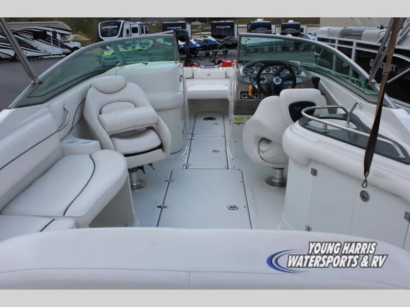 Slide: The Image of 2005 Crownline 240EX boat interior with white seating and dashboard, displayed at Young Harris Watersports & RV. - 6