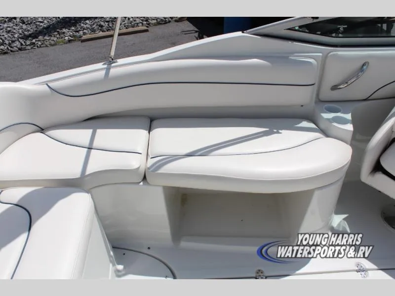 Slide: The Image of 2005 Crownline 240EX boat interior with white seating and storage compartment. - 8