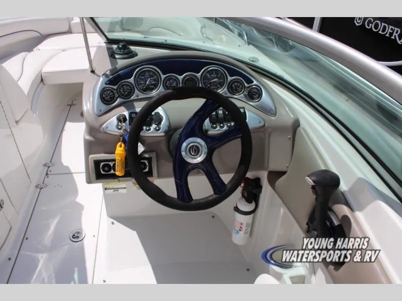 Slide: The Image of 2005 Crownline 240EX boat dashboard with steering wheel and instrument panel. - 9