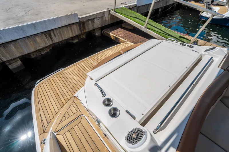 Slide: The Image of 2015 Sea Ray 350 SLX boat docked, featuring teak deck and swim platform. - 11
