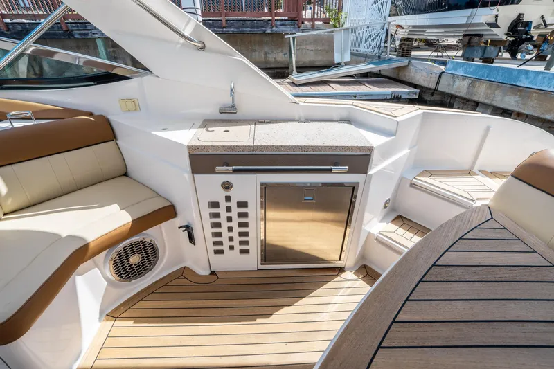 Slide: The Image of Interior of 2015 Sea Ray 350 SLX boat with seating and kitchenette. - 20