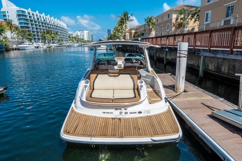 Slide: The Image of 2015 Sea Ray 350 SLX boat docked in a sunny marina setting. - 3