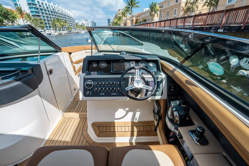 Slide: The Image of 2015 Sea Ray 350 SLX boat cockpit with modern controls and waterfront view. - 31