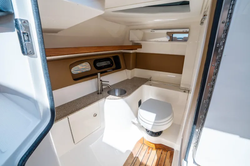 Slide: The Image of Interior of 2015 Sea Ray 350 SLX boat bathroom with sink and toilet. - 33