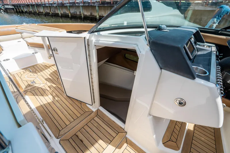 Slide: The Image of 2015 Sea Ray 350 SLX boat interior with open cabin door and teak flooring. - 34