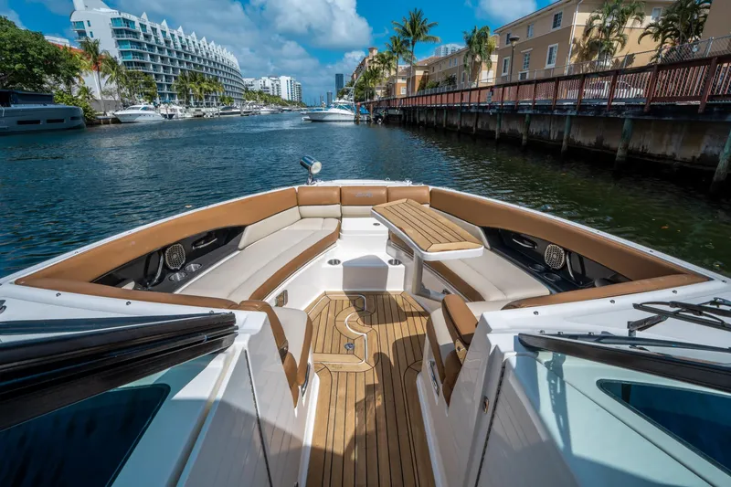 Slide: The Image of 2015 Sea Ray 350 SLX boat with luxurious seating and wooden deck in a scenic canal. - 37