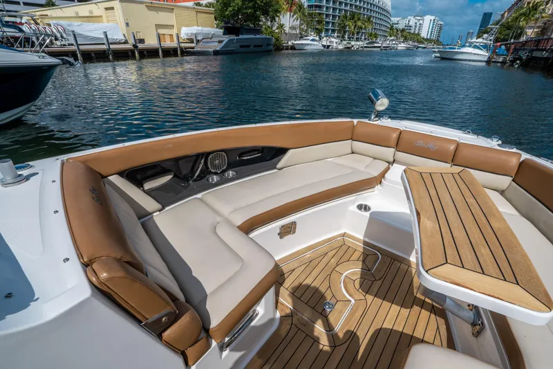 Slide: The Image of 2015 Sea Ray 350 SLX boat interior with luxurious seating and wooden table. - 38