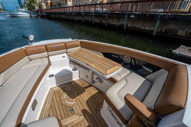 Slide: The Image of 2015 Sea Ray 350 SLX boat interior with luxurious seating and wooden accents. - 39